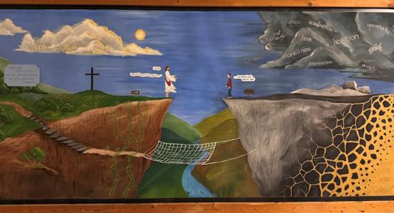 In Parkersburg Academy’s main hallway, a bulletin board hangs on a wall painted by alumna Alaina Zill, reminding students of Jesus’ promise that He’ll never leave nor forsake them. ‘Are You Still There?’, Mountain View Conference, Victor Zill, Valley Vista Adventist Center, Parkersburg Academy,