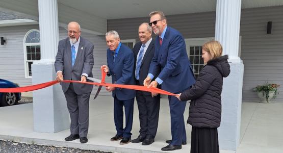 Tim Bailey, president of Mountain View Conference; Ron Higson, the oldest member of the Cumberland church; Jim Buchanan, pastor of Cumberland; Dave Weigley, president of Columbia Union; and Annalee Mellotte, the youngest member of Cumberland, celebrate the church’s building project with a ribbon-cutting ceremony