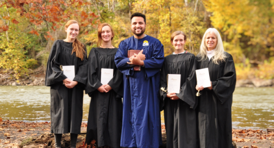 Proudly displaying their baptismal certificates, the Nonnemacher family members Tyler, Layne, Carsyn and Sharyce flank Eddie Reyes, pastor of the Rainelle church.