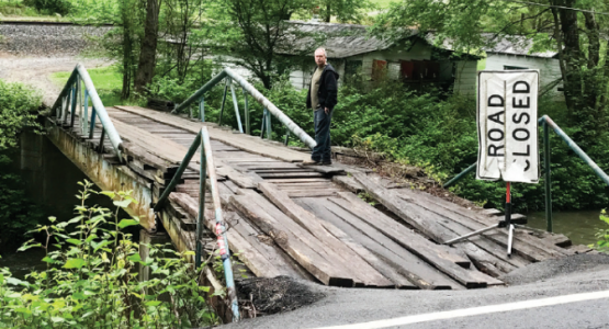 A flash flood in 2015 destroyed this bridge, making it nearly impossible for 13 Pigeon Creek families to get access to food and medical care.