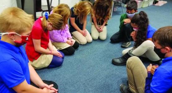 Students from the Mountain View Christian School in South Williamsport pray together.