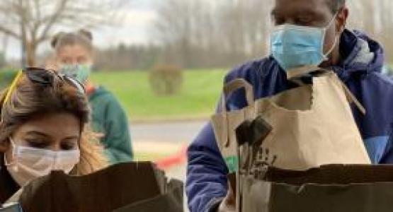 New Hope Adventist church members Tina Pillai and Timothy Atolagbe load groceries that will be taken to LARS