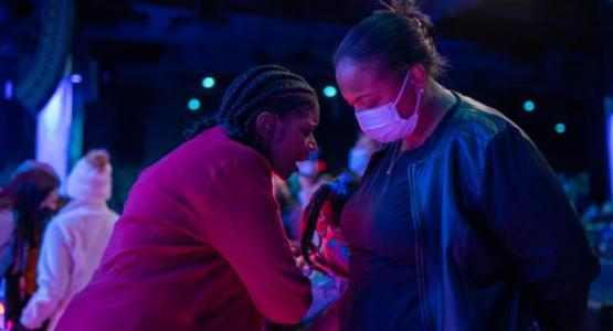 Pastor Cheryl Bridges prays with an attendee at WGTS' Night of Hope