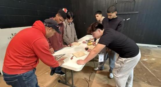 Breakout leader Enemesio Dominguez (left), guides students through a hands-on woodworking workshop. Breakout leader Enemesio Dominguez (left), guides students through a hands-on woodworking workshop.
