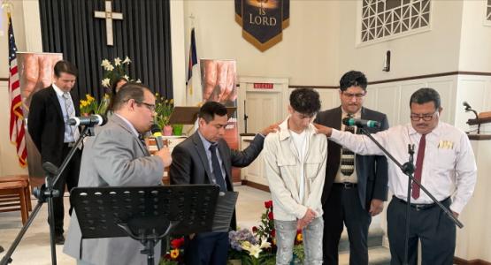 Pastor Pablo Perez (left) and elders of the Kennett Square church pray for members after their baptism. Pennsylvania Conference, Upper Darby Church, Kennett Square Church