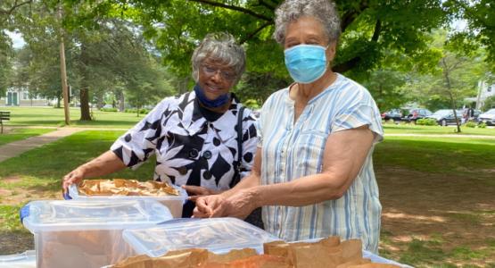 Smyrna church members Jean Culpepper and Yvonne Tucker distribute brown bag lunches to members and visitors after a worship service at Miller Park Smyrna church, Jean Culpepper, Yvonne Tucker