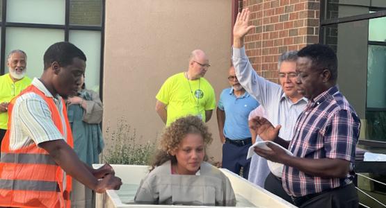 Oswaldo Magaña (with raised hand), Ohio Conference executive secretary, baptizes a new member. Owens Community College, Churches Combine Efforts in the Greater Toledo Area, Hope for Today, Bowling Green church, Toledo First church, Swanton church, Northwood church, Parkwood church, Steven Valles, Bob Cundiff, Ohio Conference, Allegheny West Conference, Columbia Union Conference