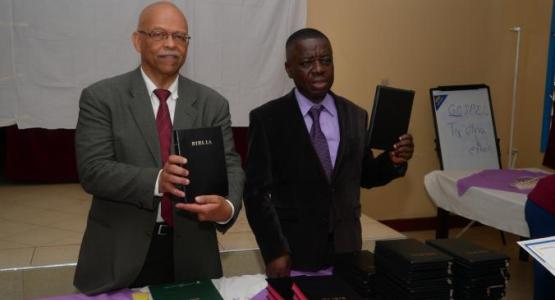 Giles McGill, president of the Abokin Evangelistic group in Africa, and Sampson Twumasi, pastor of the Columbus Ghanaian church, distribute Bibles to Sunday-keeping pastors during a graduation ceremony.