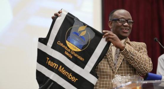 Kwabena Okyere, an elder who manages the church’s media and communication, displays one of the new volunteer vests to fellow church members.