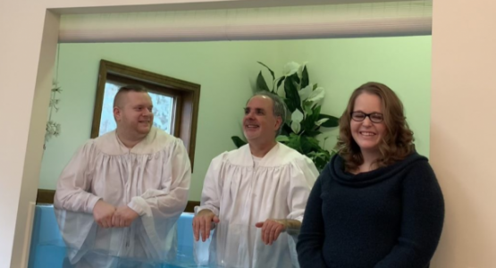 Tyler Roberts, Pastor Fred Shoemaker and Jessica Halye celebrate Roberts' baptism and Halye’s profession of faith at the Wilmington church.