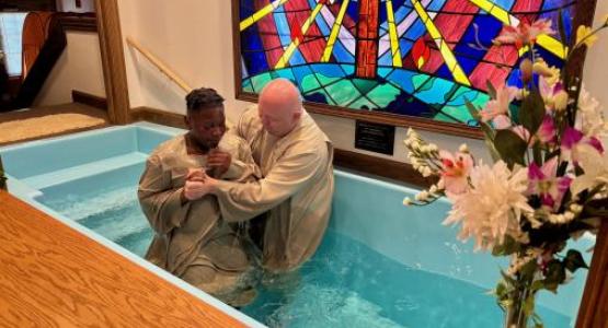 Marius Marton, pastor of the Elyria church, baptizes a new member. Marius Marton, pastor of the Elyria church, baptizes a new member.
