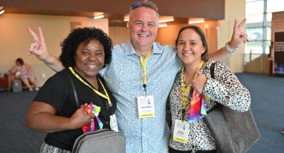 Rick Bianco, Ohio Conference superintendent of schools, greets Adelina Simpson and Cinthya Hernandez, Clifton Christian Academy educators.