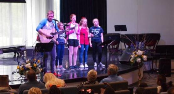Chaplain Justin Janetzko and the praise team lead students and faculty in singing an original song Janetzko wrote to honor Stephanee Oberer and her dedication to SVA.