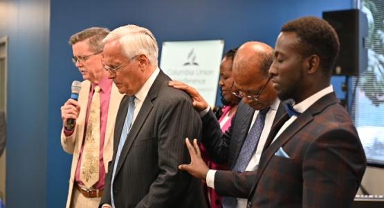 Pastor Greg Carlson and the Columbia Union Executive Officers pray over Rubén Ramos before his retirement. 