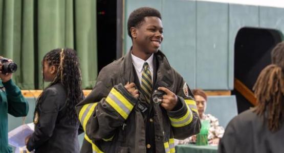 Freshman Ethan Blackwell tries on a firefighter suit during the career fair. Freshman Ethan Blackwell tries on a firefighter suit during the career fair.