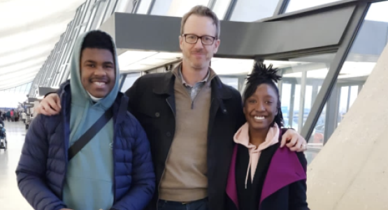 Jonathan Scriven, associate director of the Honors College at Washington Adventist University, is flanked by juniors Lawrence Wells and Azrielle Privette prior to flying to The Hague International Model United Nations conference.