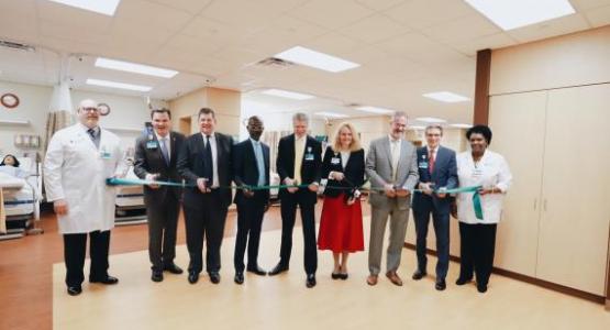 Phillip Smith, IPE Sim Center Simulation Technician; Nate Brandstater, Kettering College President; John Jervis, Kettering College board member; Donovan Ross, Kettering College board member; Walter Sackett, president of Kettering Medical Center System; Dr. Paula Reams, Director of the Division of Nursing at Kettering College; Winston Baldwin, Kettering College board member; Rick Thie, president of Kettering Medical Center Foundation, and Beverly McLean, IPE Sim Center Nursing Coordinator all pose before cut