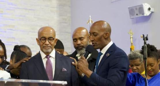 John Nixon (right), Potomac Conference’s vice president for Pastoral Ministries, prays over Dedrick Blue, the new senior pastor of the Seabrook church. Photo by Andrew Jarrett