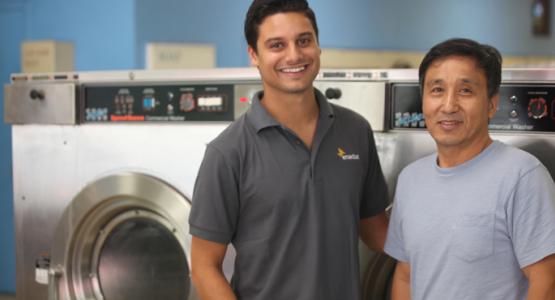 Ross Patterson photographed Enactus member Levi Soares and owner Nok Kim in the Rainbow Coin Laundry in Silver Spring, Md.,