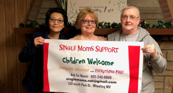 Surrounded by church members Annabel Murphy and Sue Walter, Naomi Tricomi, pastoral assistant for the Weirton/Wheeling, W.Va., district, together display an advertising banner for a Single Mom’s Ministries event. Surrounded by church members Annabel Murphy and Sue Walter, Naomi Tricomi, pastoral assistant for the Weirton/Wheeling, W.Va., district, together display an advertising banner for a Single Mom’s Ministries event.