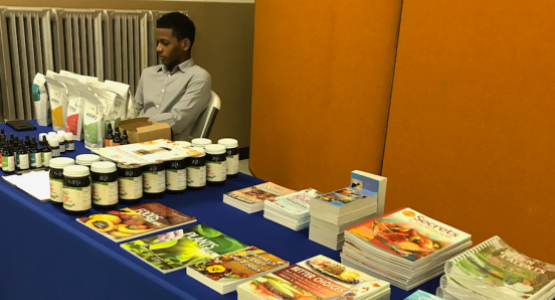 Wellness instructor Ezra St. Juste staffs the natural remedy literature display table at the Community Health Expo. Wellness instructor Ezra St. Juste staffs the natural remedy literature display table at the Community Health Expo.