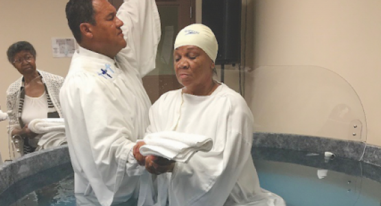 Stephen D. Lewis, pastor of the Dayton church, baptizes Brenda Rutledge. Stephen D. Lewis, pastor of the Dayton church, baptizes Brenda Rutledge.