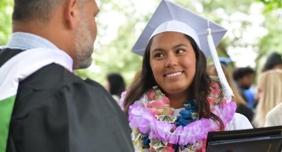 Ceiry Flores (’21) receives congratulations from Joe Lowe, recruiter and business teacher. Joe Lowe, Ceiry Flores