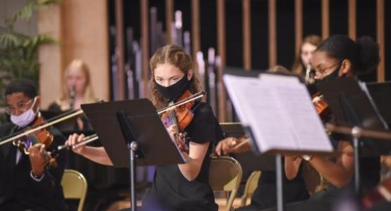 Strings players Joseph Pelote (’24), Ellie Anderson (’23) and Anisa Phillip (’24) perform during the annual Candlelight Concert.