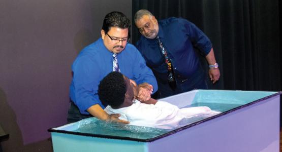 Luis Camps baptizes senior Christopher Cadet. Photo credit: Ross Avery Gordon Luis Camps baptizes senior Christopher Cadet. Photo credit: Ross Avery Gordon