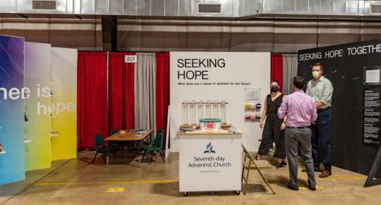 A view of Triadelphia Seventh-day Adventist Church’s “Seeking Hope” booth at the Howard County Fair in West Friendship, Maryland, in August 2021. From left: volunteers Callie Buruchara, Chandler Riley, and Brody Wiedemann. Credit Tony Williams 