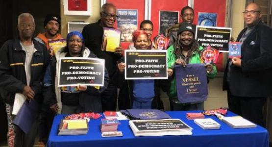 Jerome Hurst, pastor of the Southeast church, and a team of canvassers display “pro-voting” signs prior to Election Day.