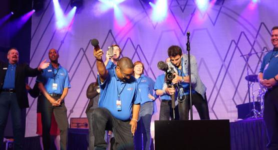 1. The WGTS 91.9 team records the audience singing the jingle. Left to right – PM Drive Host Johnny Stone; AM Drive Host Jerry Woods; Traffic anchor Tom Miner; PD Brennan Wimbish, Midday host Becky Alignay, Music Director Rob Conway; Video director Eugene Simonov and General manager Kevin Krueger. 