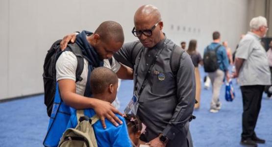 Sibusiso B. Khumalo, director of GC Youth Ministries, prays with a young person at the General Conference Session. Photo by Nicol Belvedere/AME (CC BY 4.0) Sibusiso B. Khumalo, director of GC Youth Ministries, prays with a young person at the General Conference Session. Photo by Nicol Belvedere/AME (CC BY 4.0)
