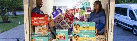 WGTS 91.9 Hands and Heart volunteers Eric and Pat organize diapers in the box truck.