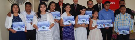 New members display their baptismal certificates.