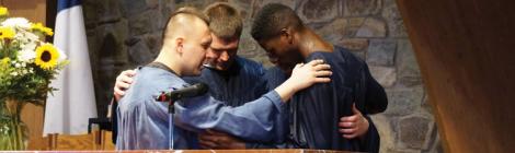 Justin Montero and Spencerville youth pastor Stephen Finney pray with Jacob Harris at Harris’ baptism. Photo credit: Juliana Baioni