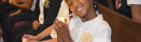 Fourth-grader Zaria Sway holds a candle to represent the light of God’s Word.
