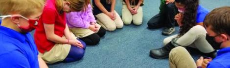 Students from the Mountain View Christian School in South Williamsport pray together.