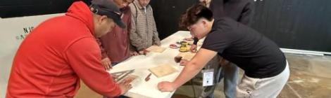 Breakout leader Enemesio Dominguez (left), guides students through a hands-on woodworking workshop.