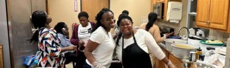 Columbus Ghanaian church members Patience Adjei and Serwaa Afrifa serve food to the youth and young adults.