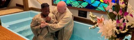Marius Marton, pastor of the Elyria church, baptizes a new member.