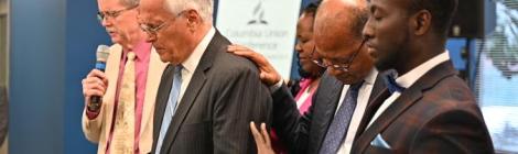Pastor Greg Carlson and the Columbia Union Executive Officers pray over Rubén Ramos before his retirement. 