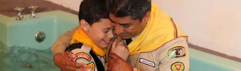 Pastor Marco Estrada baptizes a new member at Vineland Caravan of Compassion stop.
