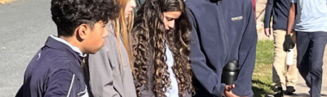 While prayer walking in the school’s neighborhood, eighth grade students pause to ask God’s blessing on a home. While prayer walking in the school’s neighborhood, eighth grade students pause to ask God’s blessing on a home.