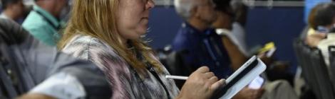 Reina Zapata-Mendez, a delegate to the General Conference Session and lay member from the New Jersey Conference, diligently takes notes during the business proceedings. Photo by Kelly Butler Coe.