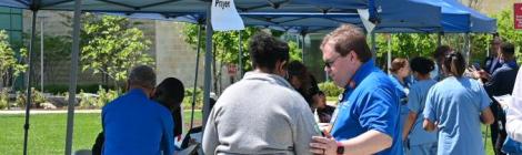 Adventist HealthCare Chaplain Ryan Ryan Comeau prays with an attendee