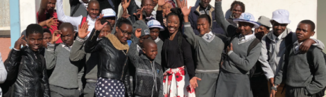 Sidney Harris (white skirt), a member of the Ephesus church in Richmond, Va., waves hello with a group of students who decided to get baptized as a result of Harris’ ministry in Lesotho.