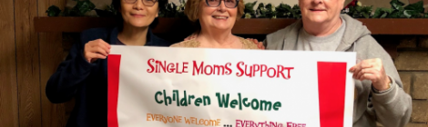 Surrounded by church members Annabel Murphy and Sue Walter, Naomi Tricomi, pastoral assistant for the Weirton/Wheeling, W.Va., district, together display an advertising banner for a Single Mom’s Ministries event.