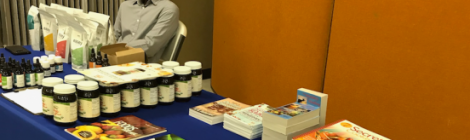 Wellness instructor Ezra St. Juste staffs the natural remedy literature display table at the Community Health Expo.