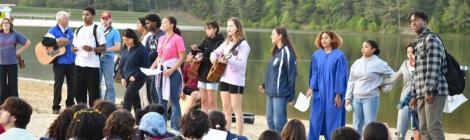 Zaida Galva (in robe) and her friends lead students in praise and worship during the baptismal celebration.